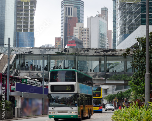 Busy city street,  double-decker trams, day in big town, urban life. Daily routine, intensity of streets in Hong Kong. © Lina