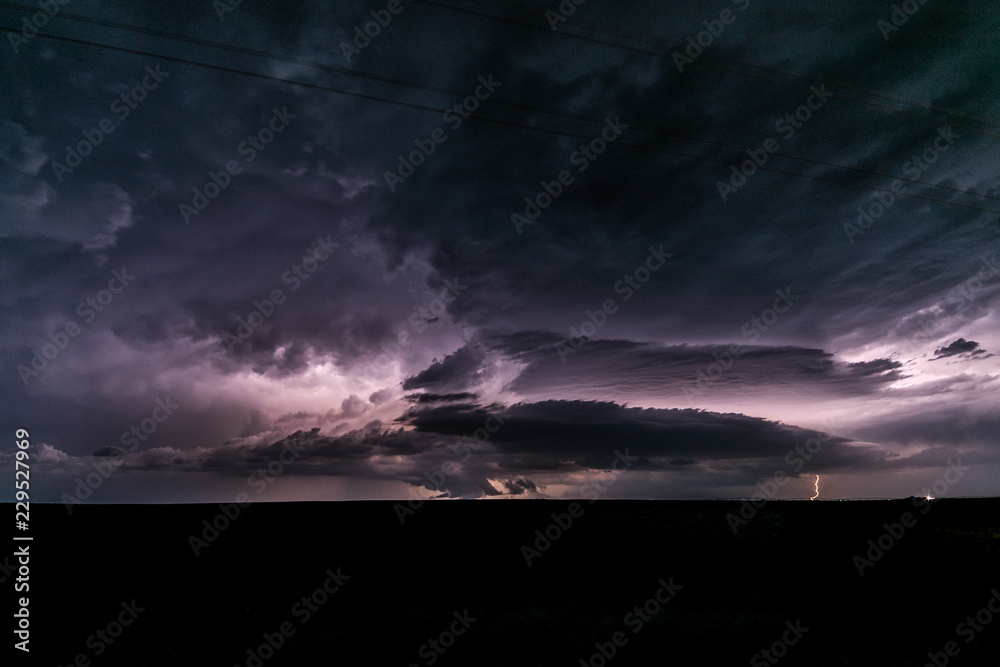 A supercell thunderstorm produces lightningbolts over the Great Plains