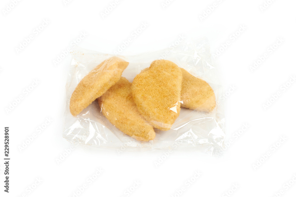 fried chicken breast in a transparent packageon white background. fried chicken breast in a transparent packageon white background.