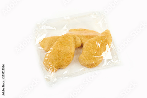 fried chicken breast in a transparent packageon white background.