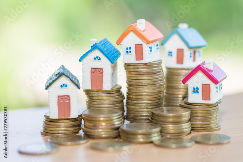 Mini house on stack of coins, Real estate investment, Save money with stack coin, Business growth investment and financial, Mortgage concept.