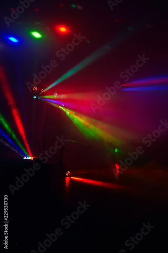 Stage lights in action at the concert. Lights show. Lazer show. Night club dj party people enjoy of music dancing sound with colorful light. club night light dj party club. Smoke Machine and lights