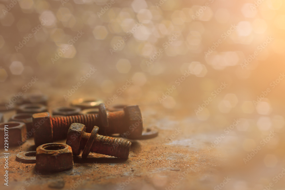 Group of old rusty nuts and screws pile on the dusty floor with selective focus and copy space, Processed in Vintage style and sunset flare, Background for machanical or recycle concept Group of old rusty nuts and screws pile on the dusty floor with selective focus and copy space, Processed in Vintage style and sunset flare, Background for machanical or recycle concept