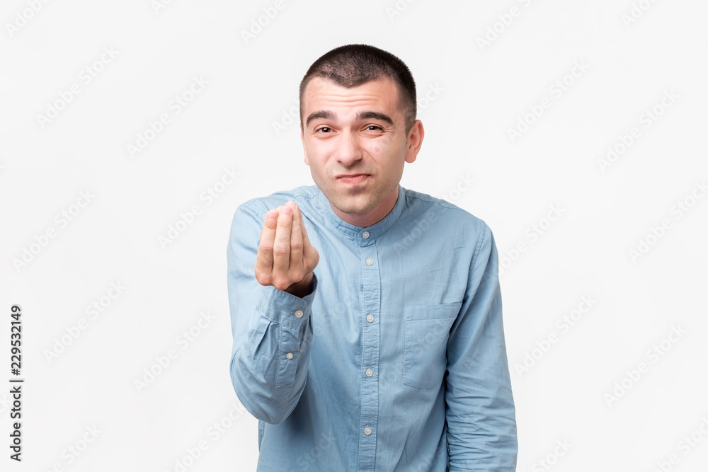 Young handsome man showing italian gesture that means what do you want over white background.