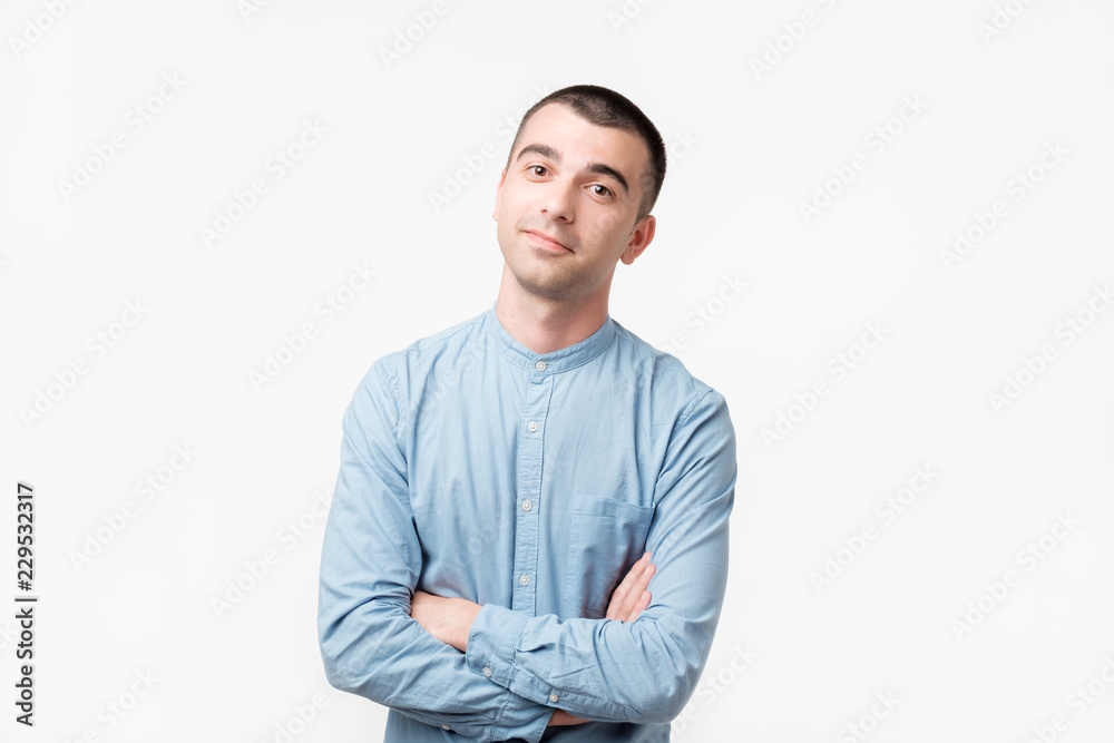 Attractive caucasian male making bothered face, being indifferent and listening without lack of interest