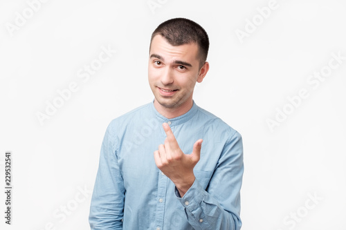 Φωτογραφία Playful adult showing come here gesture with index finger and smiling