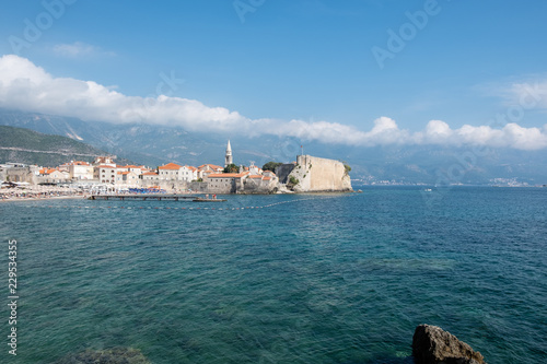 Fototapeta Naklejka Na Ścianę i Meble -  Budva. The old Town. Cloudy sky over houses Adriatic Sea. Montenegro. Europe.