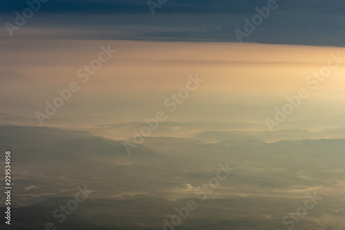 Morning mist covered mountains and sunlight.