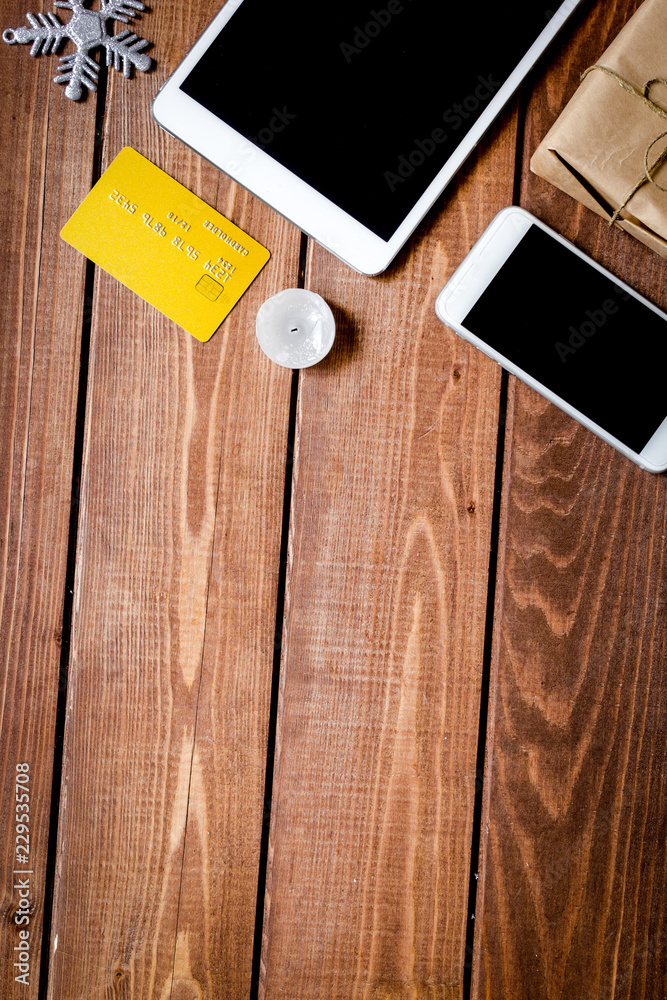 smartphone, tablet, shopping for new year online wooden table