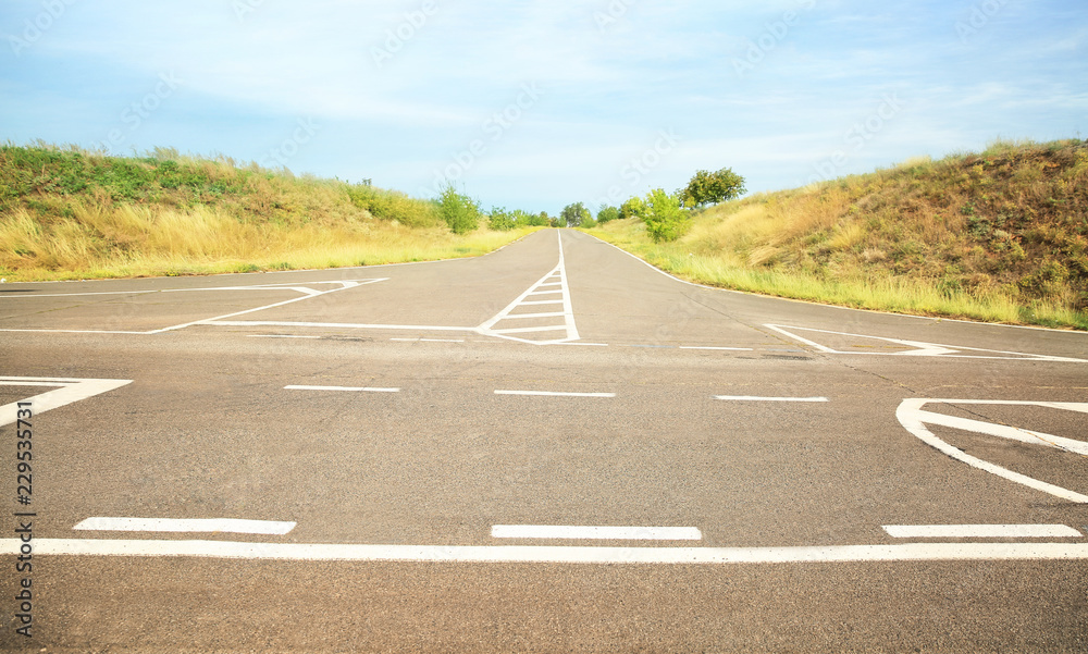 Fototapeta premium Empty asphalt crossroad in countryside