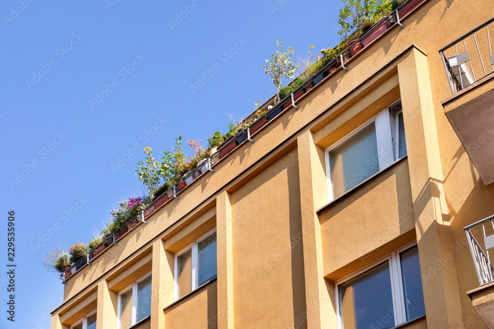 View of beautiful building with flowers on roof