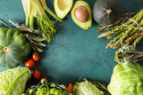 Frame made of various fresh vegetables on color background