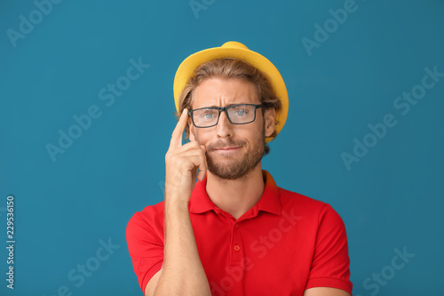 Thoughtful young man in yel...