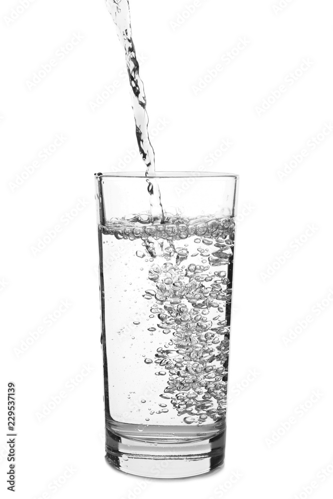 Pouring of water in glass on white background Pouring of water in glass on white background