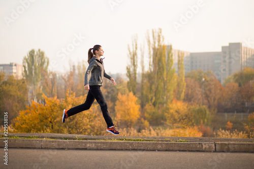 Woman running in autumn fall forest. Healthy lifestyle