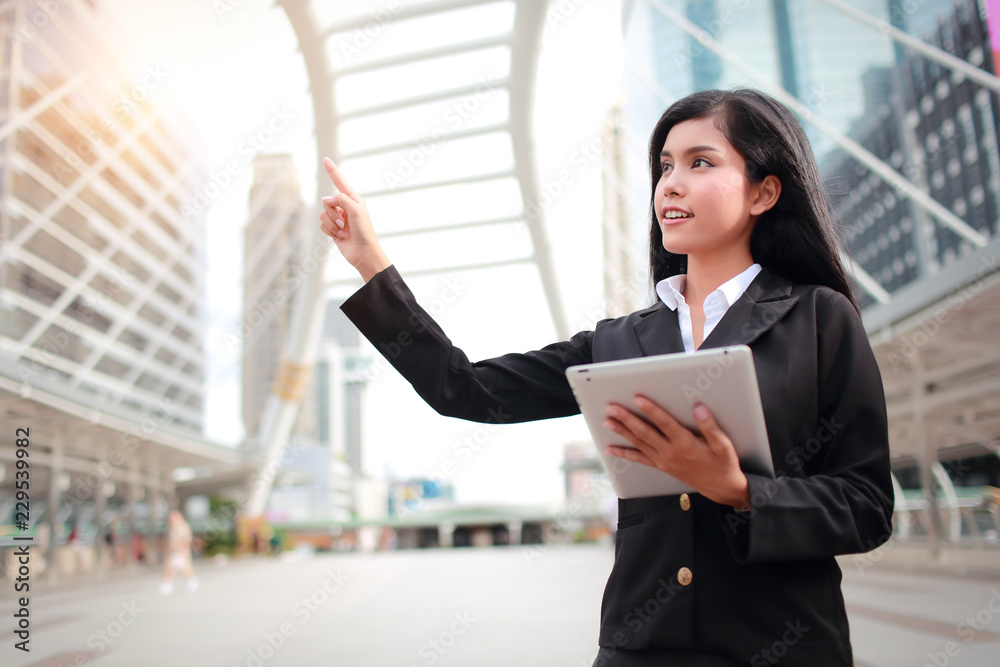 businesswoman using tablet and pointing fingure businesswoman using tablet and pointing fingure