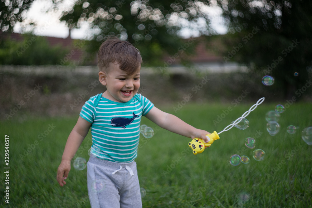 boy playing with soap bubbles boy playing with soap bubbles