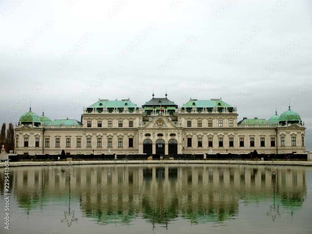 Belvedere Palace reflected in the water in a foggy day, Vienna, Austria