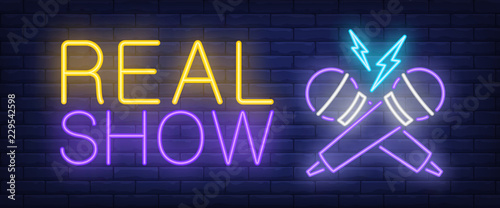 Real show neon sign. Crossed microphones on brick background. Karaoke, concert, nightclub. Night bright advertisement. Vector illustration in neon style for entertainment, leisure, nightlife