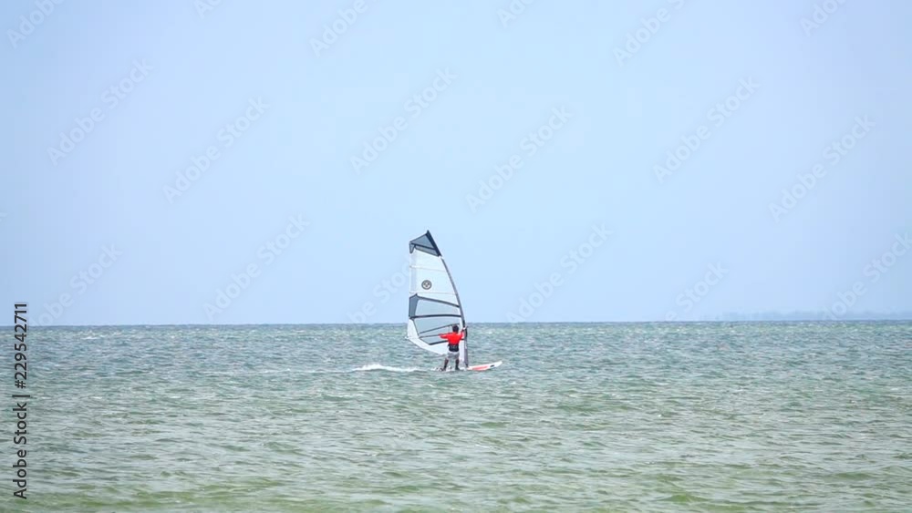 slow motion Windsurfer silhouette over sea slow motion Windsurfer silhouette over sea