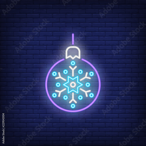 Christmas ball neon sign. Luminous signboard with purple bauble with snowflake. Night bright advertisement. Vector illustration in neon style for decoration, decor