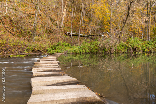 Hiking Trail Crossing River In Autumn 