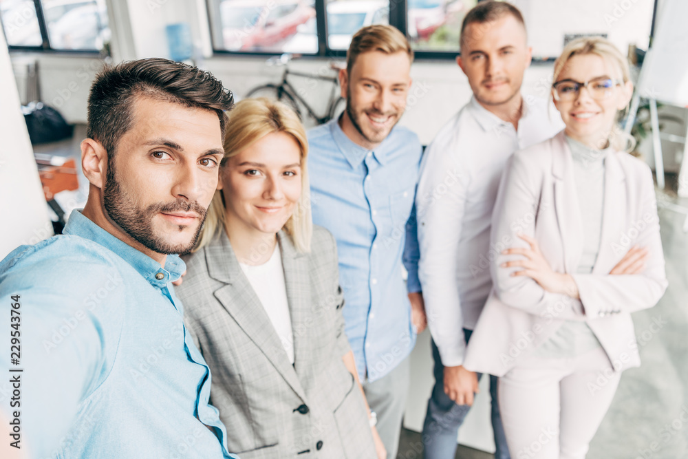 confident young start up team smiling at camera in office