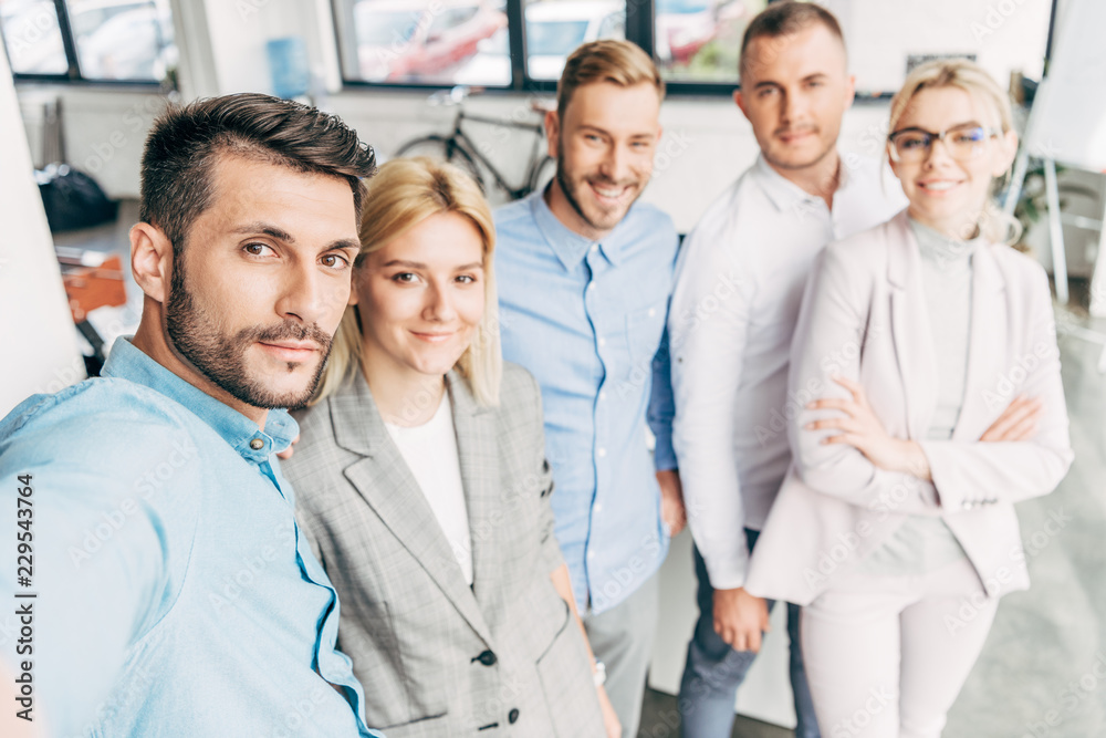 confident young start up team smiling at camera in office confident young start up team smiling at camera in office