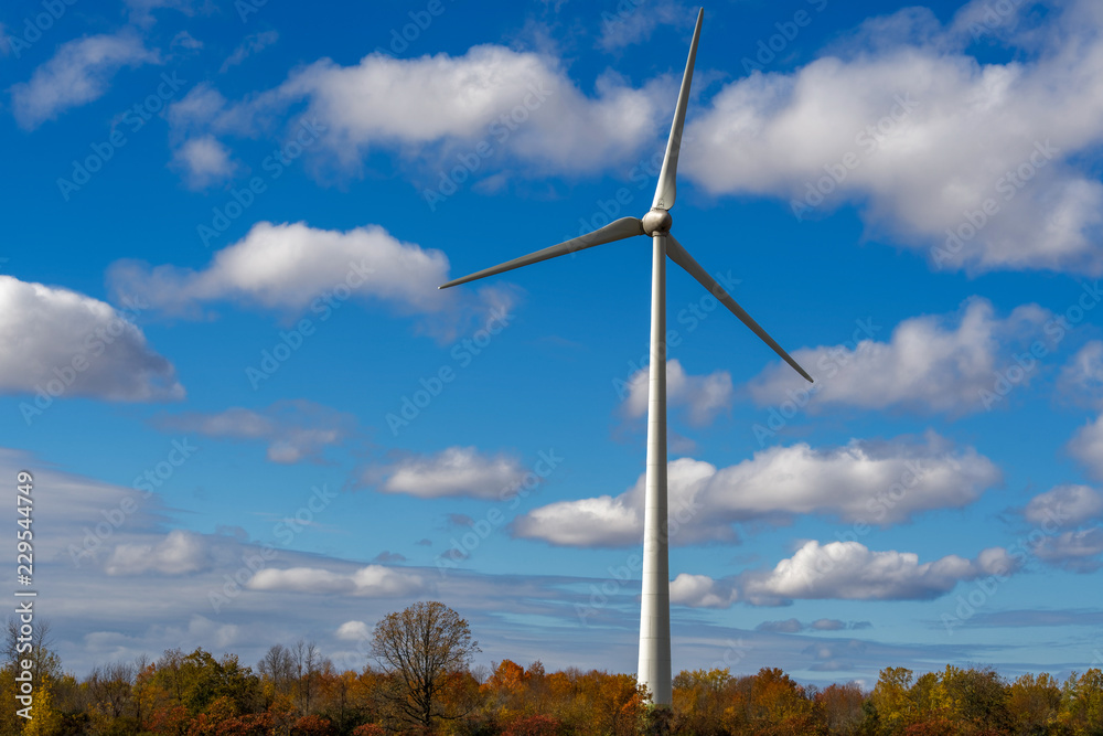 Wind turbine close up with blue sky and clouds in Quebec