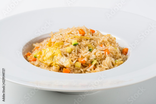 Rice sautéed with vegetables and egg on white background