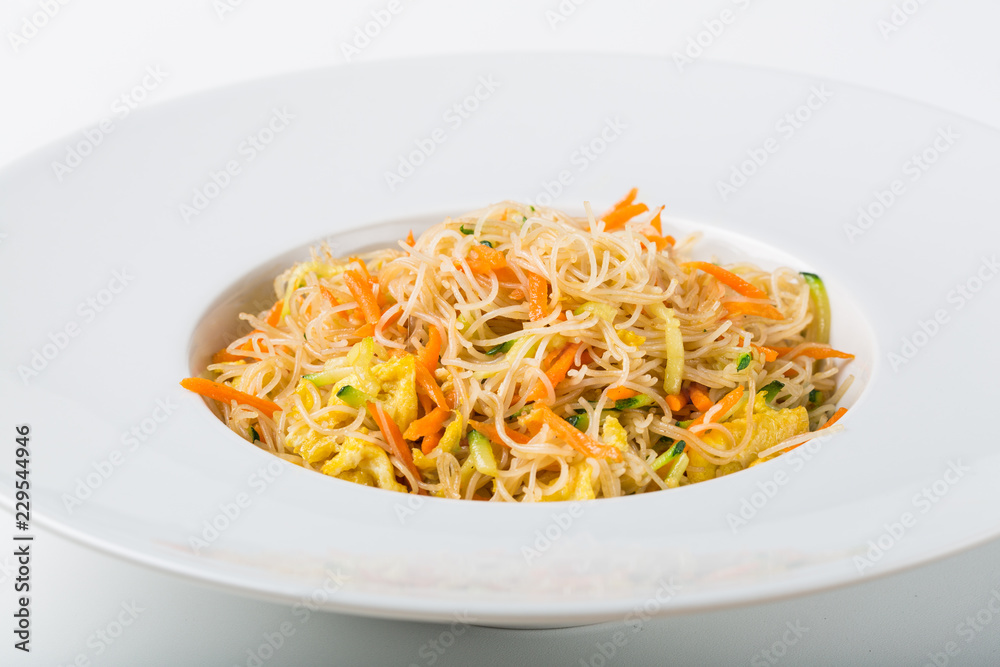 Grilled soy spaghetti with vegetables and egg on white background Grilled soy spaghetti with vegetables and egg on white background