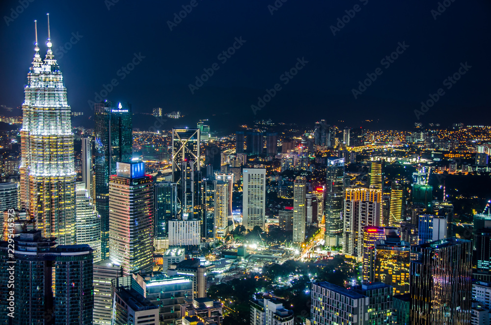 Famous Petronas Twin Towers skyscrapers Kuala Lumpur, Malaysia. Aerial skyline view at night
