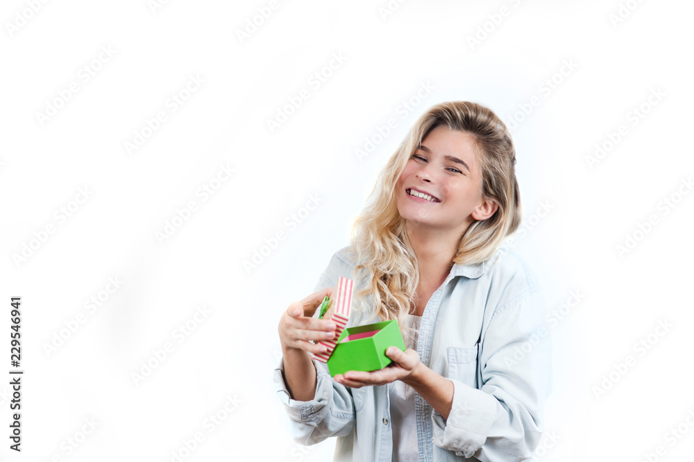 a very beautiful young emotional girl rejoices at the received gift and screams with happiness on a white isolated background a very beautiful young emotional girl rejoices at the received gift and screams with happiness on a white isolated background