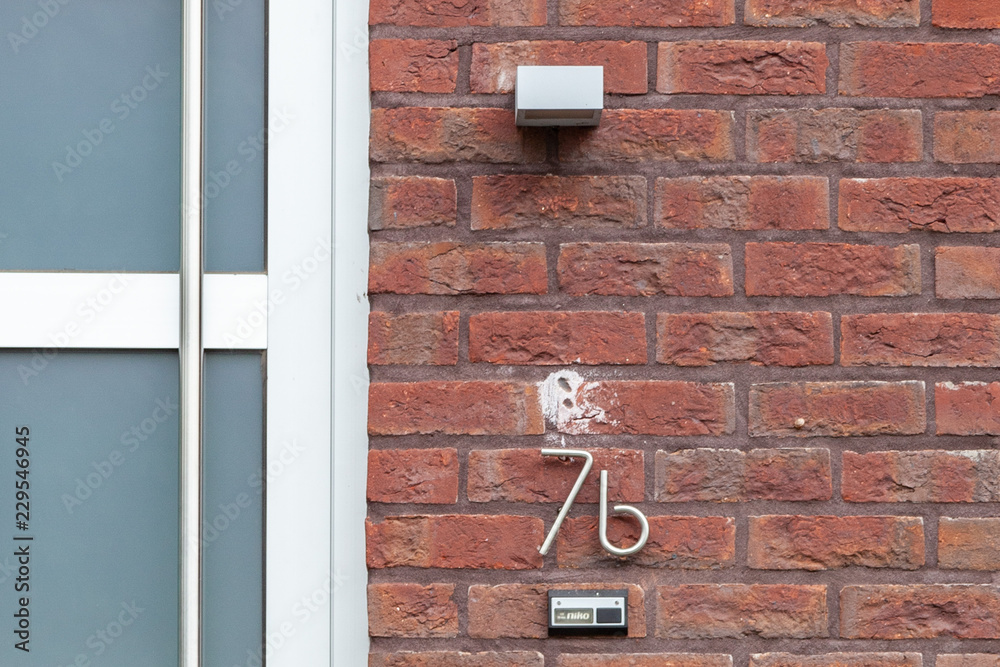 House number seven B 7B in curved and twisted metal - stainless steel, in designer font from Sweden