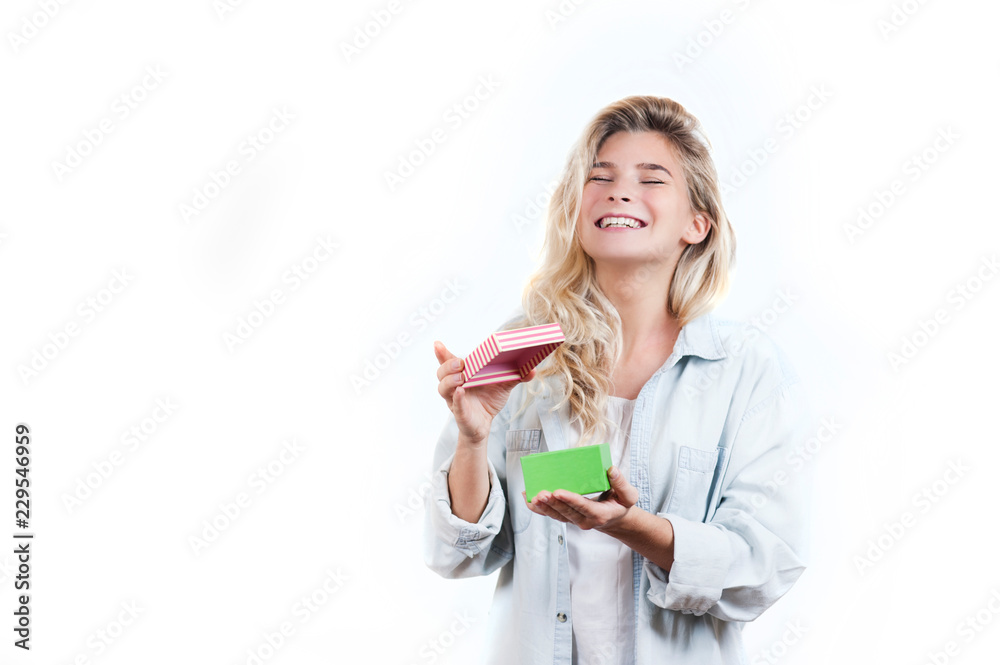 a very beautiful young emotional girl rejoices at the received gift and screams with happiness on a white isolated background a very beautiful young emotional girl rejoices at the received gift and screams with happiness on a white isolated background