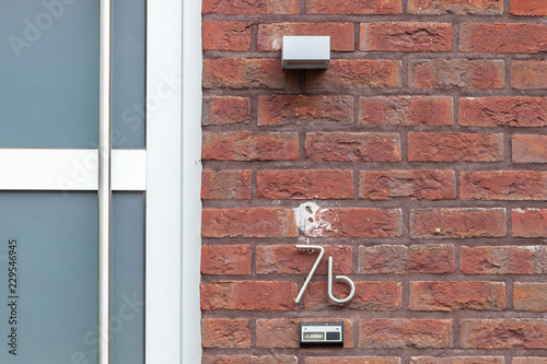 House number seven B 7B in curved and twisted metal - stainless steel, in designer font from Sweden