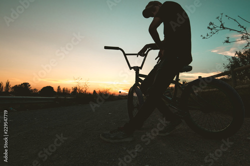 Silhouette of a guy with a bmx bicycle