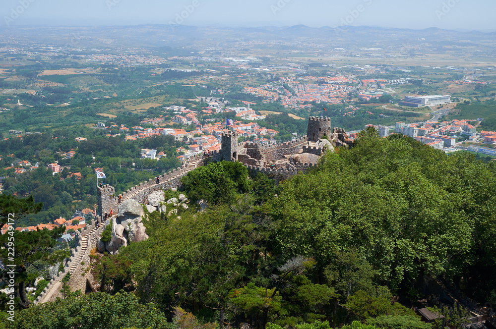 View of Castle of the Moors on the top of the mountain over the Sintra town. Sintra. Portugal