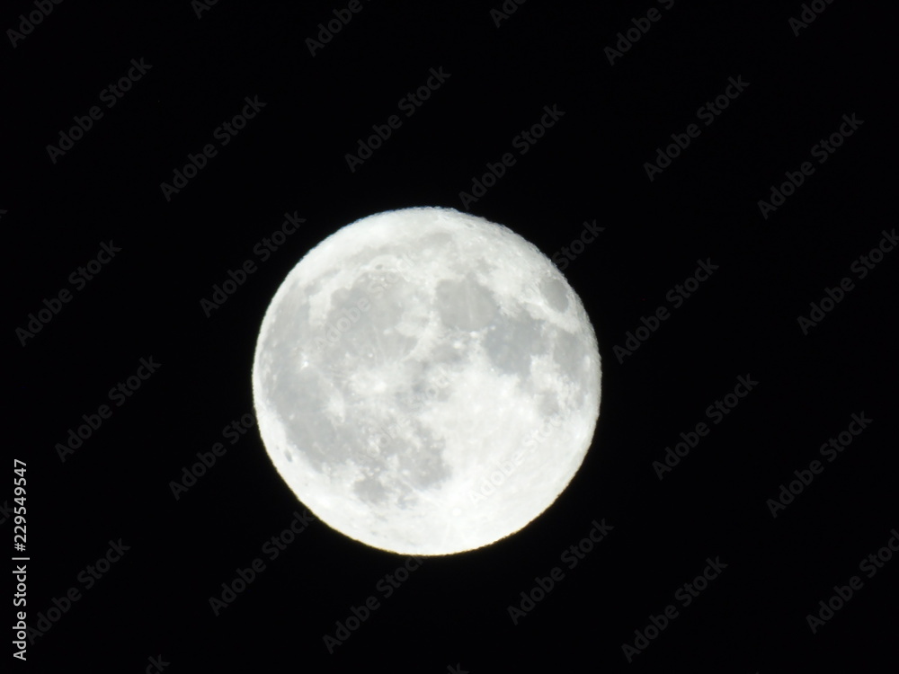 An amazing caption of the full moonlight over the city by night in summer days with some clouds and foggy An amazing caption of the full moonlight over the city by night in summer days with some clouds and foggy