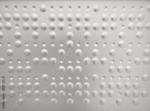 Braille like pattern in a metal surface