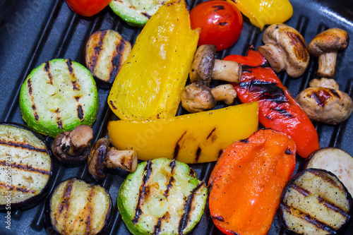 Cooking vegetables and mushrooms on grill pan 