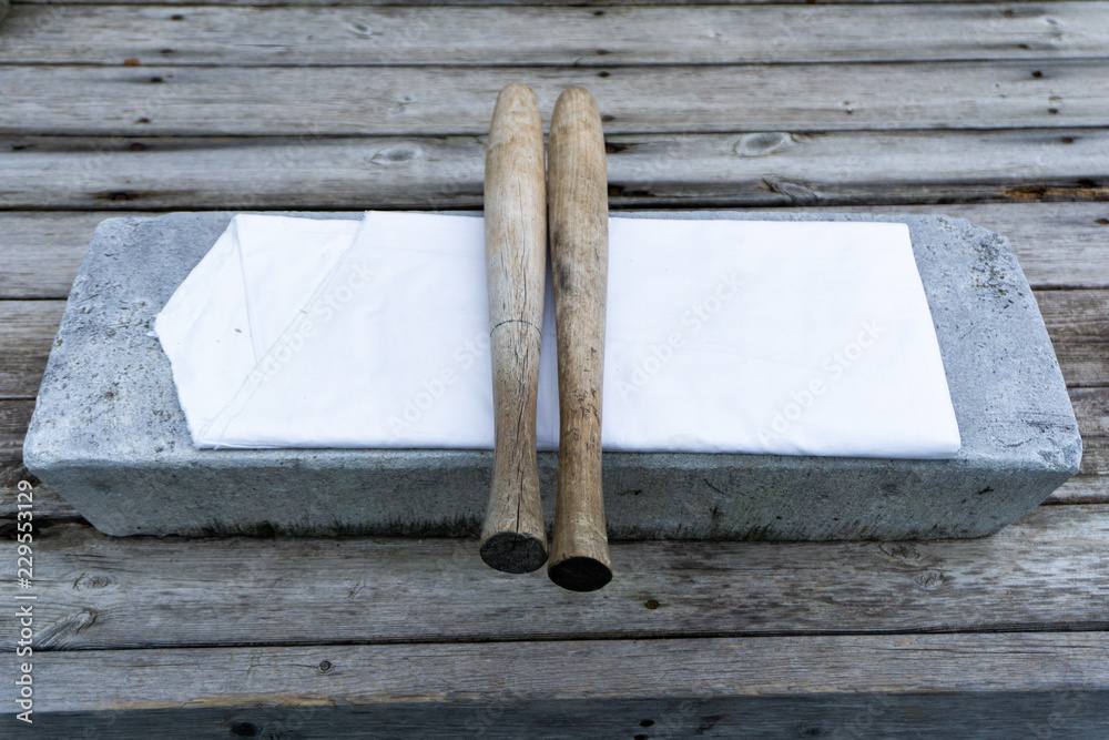 Long, round wooden bat use for beat cloths called "pangmangi" and flat  stone use for lay