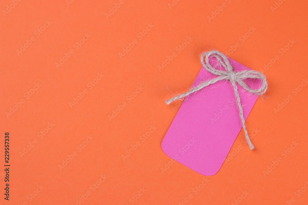 Black Friday. The concept of shopping. sale. Pink sale price tag on orange background. view from above