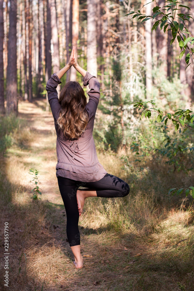 Beautiful young girl meditating in autumn park Beautiful young girl meditating in autumn park