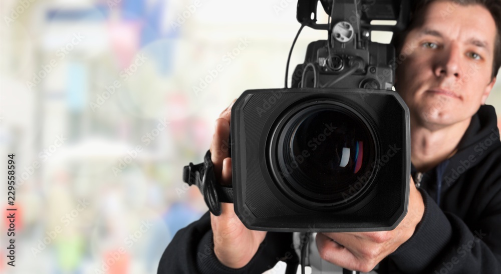 Cameraman working with camera  on background