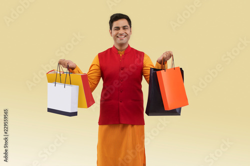 Portrait of a Man holding shopping bags