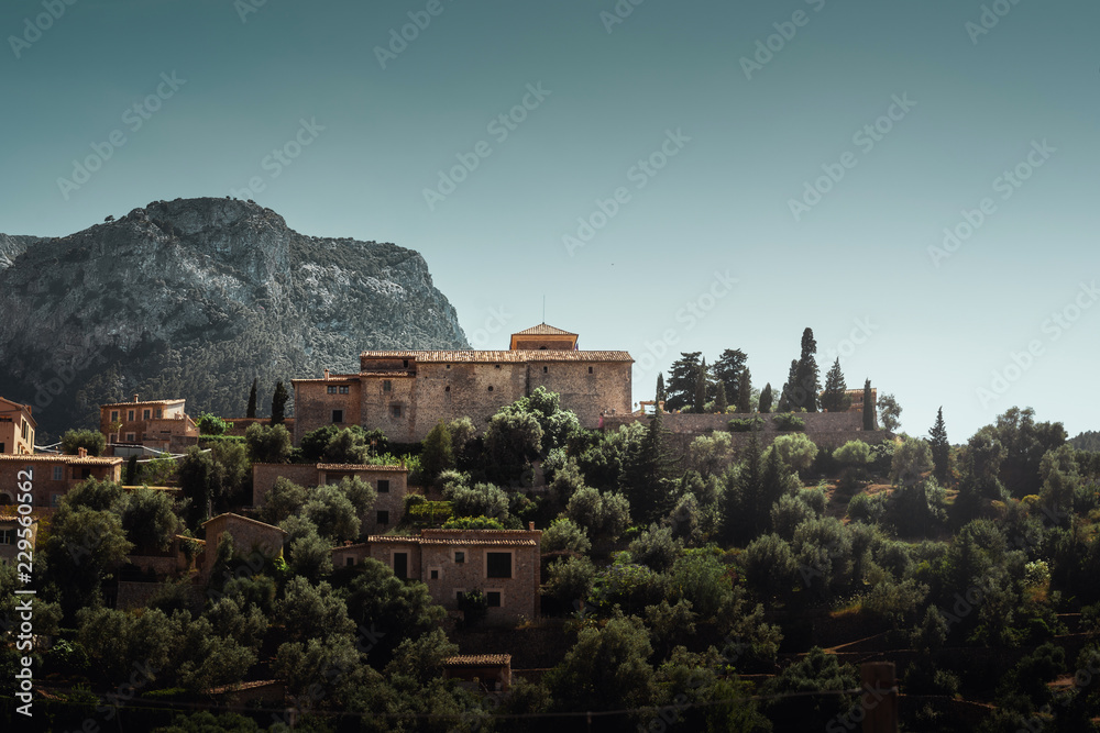 Old castle on mallorca, spain with mountains in background