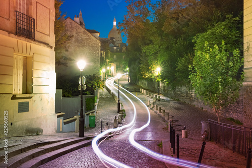 Empty cozy street and the Sacre-Coeur Basilica at night, quarter Montmartre in Paris, France © Kavalenkava