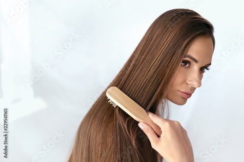 Beauty Hair Care. Beautiful Woman Brushing Long Healthy Hair 