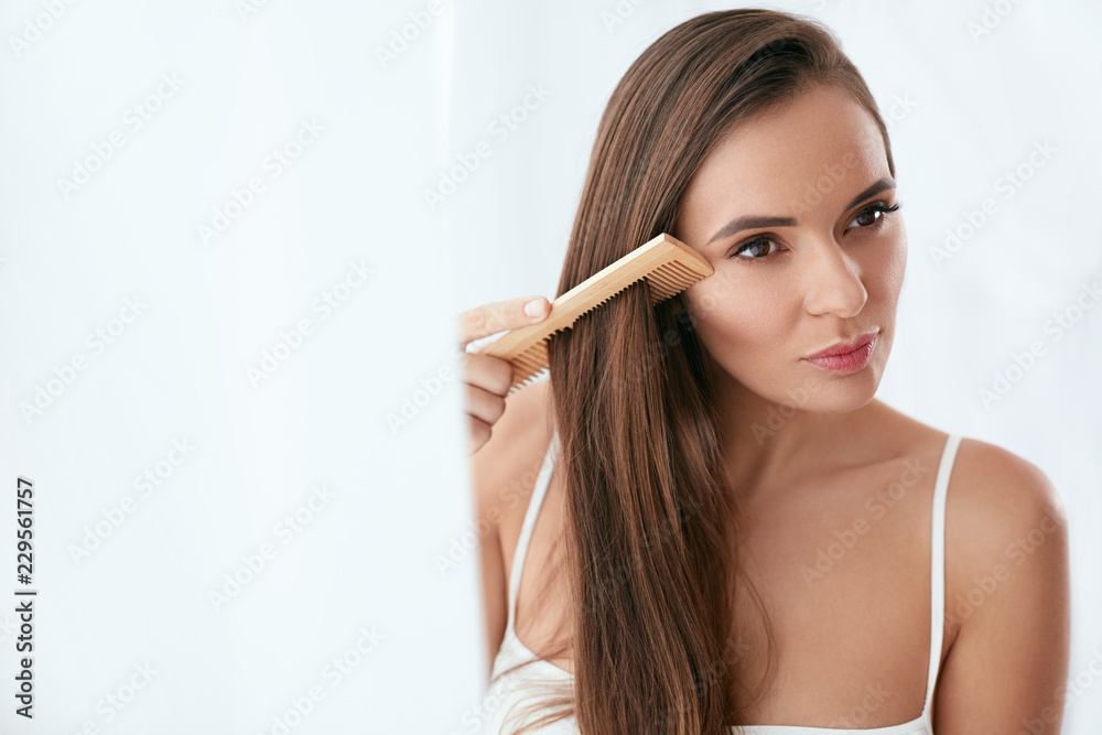 Hair Care. Woman Combing Beautiful Long Hair With Wooden Brush Hair Care. Woman Combing Beautiful Long Hair With Wooden Brush
